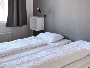 two unmade beds in a room with a lamp at 10 person holiday home in SÄLEN in Stöten
