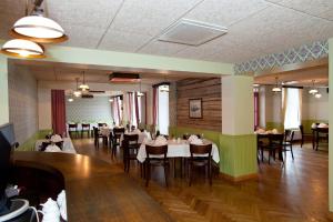 a dining room with tables and chairs in it at Hotell Räpina in Räpina