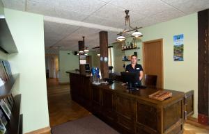 a woman standing at a reception desk in a salon at Hotell Räpina in Räpina