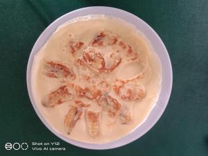 a plate of food with shrimp in a bowl of milk at Yayan Bungalow in Gili Islands