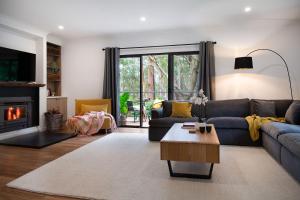a living room with a couch and a fireplace at Selo Retreat in Glenlyon