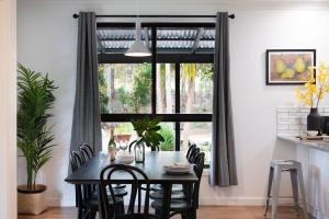 a dining room with a table and chairs in front of a window at Selo Retreat- escape to this forest retreat in Glenlyon +14 photos