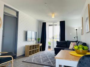 a living room with a couch and a table at Port Vista - Central Fremantle Apartment in Fremantle