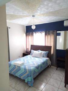 a bedroom with a bed with a blue ceiling at Crystoural Apartment Liguanea Sovereign Apt - 2 Bedrooms, 3 Beds, Host 4 Guest- Kingston! in Kingston +51 photos
