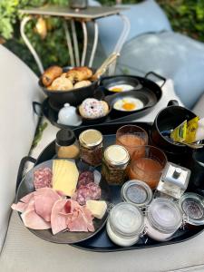a tray of food with different types of breakfast foods at Domaine 10 in Schore
