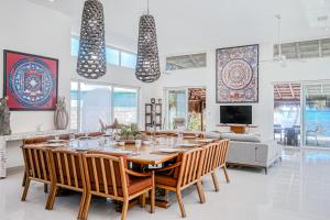 a dining room with a large table and chairs at Villa Tankah Mandala in Tulum