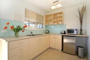 a kitchen with a sink and a microwave at A River Bed in Aireys Inlet