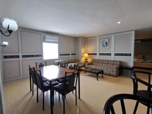 a living room with a table and chairs and a couch at Holiday Plaza Hotel - Cebu in Cebu City