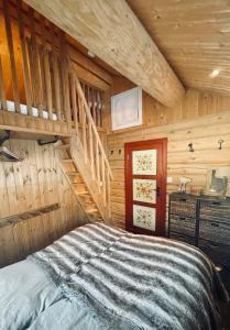 a bedroom with a bed in a wooden room at Vasethytta - cabin with a lovely view in Brujordet