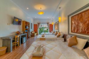 a large living room with a large bed in the middle at Angkor Rithy Boutique in Siem Reap