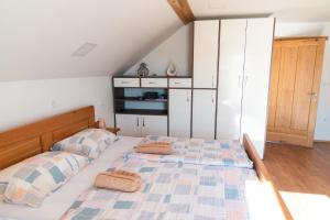 a bedroom with a bed with two pillows on it at Apartma ''Pri Movernu'' in Semič
