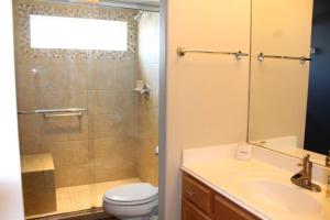 a bathroom with a toilet and a sink and a shower at Enjoy Our Ocean Oasis in Galveston +32 photos