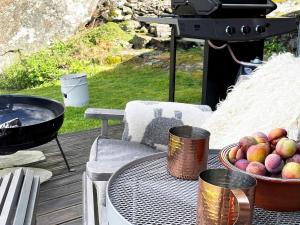 a table with a bowl of apples on a grill at Four-Bedroom Holiday home in Jelsa 2 in Jelsa