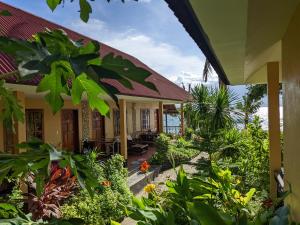 a house with a garden in front of it at Tipolo Beach Resort in Moalboal