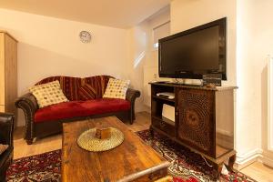 a living room with a television and a coffee table at TOP SPOT - KREUZBURG CENTRAL THE PLACE TO BE ! in Berlin