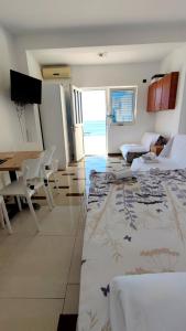 a living room with a table and chairs and a room at Seaview, just across the beach, Bečići in Bečići