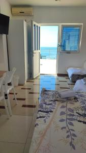 a room with a bedroom with a view of the ocean at Seaview, just across the beach, Bečići in Bečići
