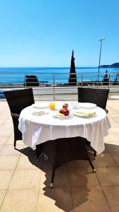a table with a plate of food on it with the ocean at Seaview, just across the beach, Bečići in Bečići