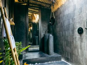 a bathroom with a tub in the side of a building at ONAYA Bali Resort - Adults Only in Uluwatu