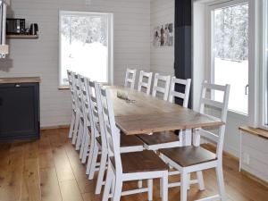 a dining room with a wooden table and chairs at 10 person holiday home in S LEN in Stöten