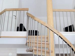 a set of wooden stairs with a dog in the background at 10 person holiday home in S LEN in Stöten