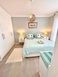 a bedroom with a large bed and two night stands at 706 Portico in Cape Town
