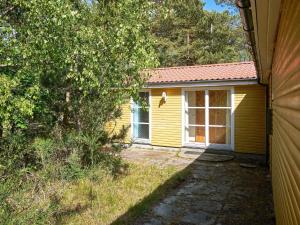 a yellow house with a window on the side of it at 6 person holiday home in Aakirkeby in Vester Sømarken