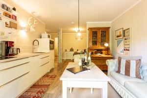 a kitchen and living room with a couch and a table at Christian in Ahrenshoop
