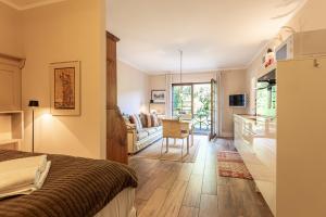 a bedroom with a bed and a kitchen with a table at Christian in Ahrenshoop
