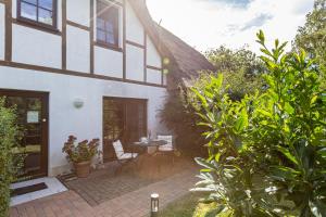 a patio of a house with a table and chairs at Christian in Ahrenshoop