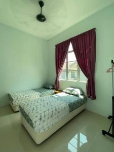 um quarto com 2 camas e uma janela em homestay kubang ikan chendering 5minit ke pantai em Kuala Terengganu