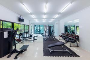 a gym with a lot of treadmills and machines at The Room at Maesai in Mae Sai