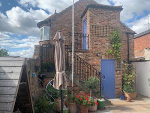 an umbrella sitting in front of a brick house at The Turret in Easingwold