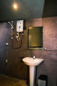 a bathroom with a sink and a mirror at The Backyard Balangoda in Balangoda