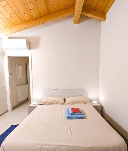 a bedroom with a bed with a blue towel on it at Agriturismo Ardizio 43 in Pesaro
