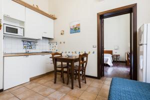 kuchnia ze stołem i krzesłami w pokoju w obiekcie Grimaldi 8 Apartment by Wonderful Italy w Katanii