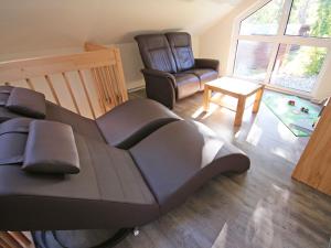 a living room with a couch and a chair at Strandhus Baabe Haus 3 in Baabe +3 photos