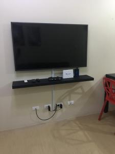 a flat screen tv on a shelf on a wall at 1 Bedroom Condo Unit at Centrio Tower in Cagayan de Oro