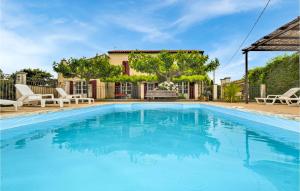 a large swimming pool with blue water in a yard at Nice Home In Maillane With Wifi in Maillane +34 photos