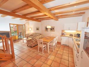 a kitchen and living room with a table and a kitchen and a dining room at Strandschlösschen Sellin - Haushälfte 2 in Ostseebad Sellin