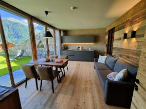 a living room with a couch and a table at Premstlahof Ferienwohnung Lärchenstube in Martello