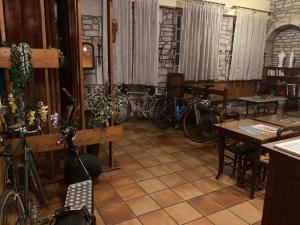 a room with a bunch of bikes parked in it at Ancien Hôtel plein de charme in Baume-les-Dames