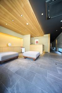 a large room with two beds in a building at Riri Kyoto in Kyoto
