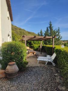 a picnic shelter with a bench and a picnic table at Antica Casa dei Contadini di Orosei in Orosei