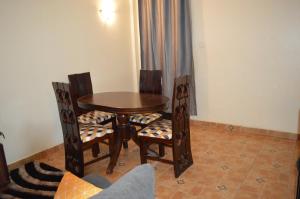 a dining room table and two chairs and a table and chairsuggest at Nikki's 2BR Home Ruiru, Thika Road in Nairobi +11 photos