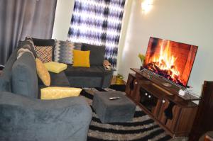 a living room with a couch and a fireplace at Modern Ruiru double deluxe, Thika Road in Ruiru