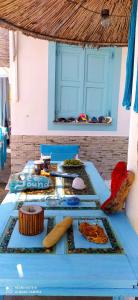 a blue table with plates of food on it at SEA SOUND Villa in Ágios Dimítrios