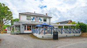 a house with an umbrella in front of it at The Running Horse in Winchester