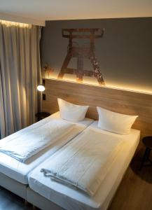 a bedroom with a large bed with the eiffel tower at Haus Hohenstein in Witten