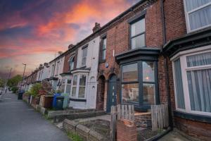 a row of brick houses on a city street at Stylish 3 Bed - Entire House- Near City Ctr & SUFC in Sheffield